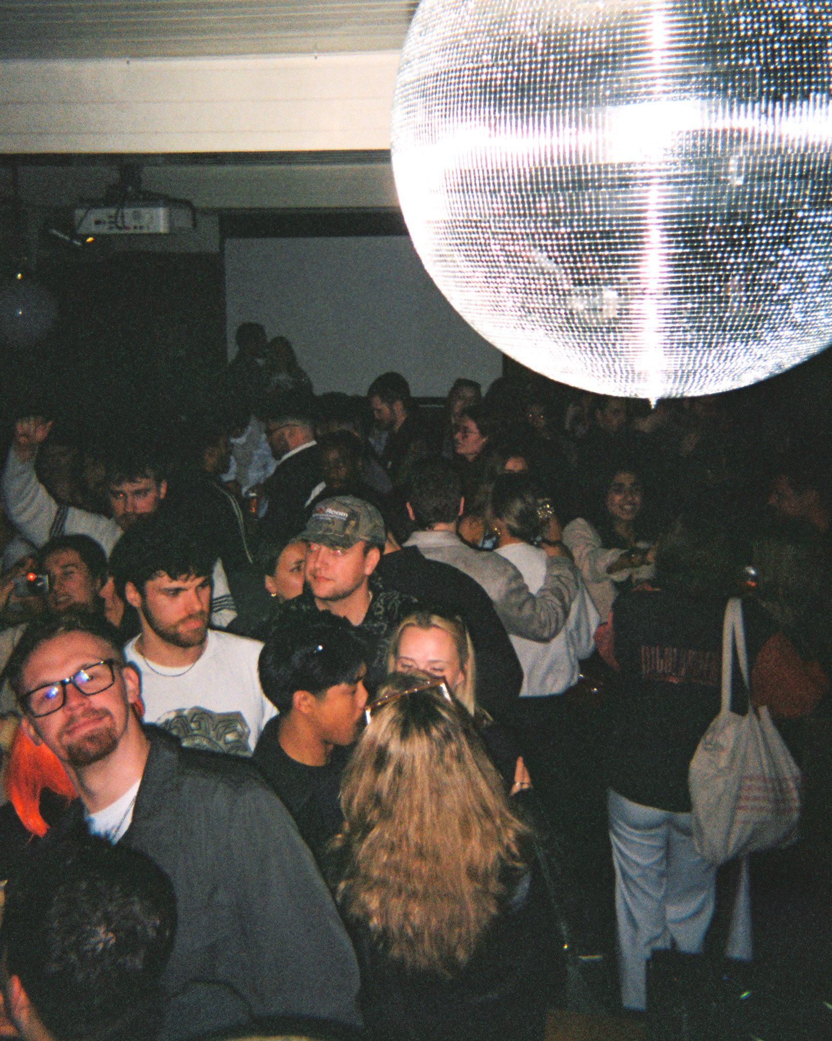 Photo of crowd under a disco ball